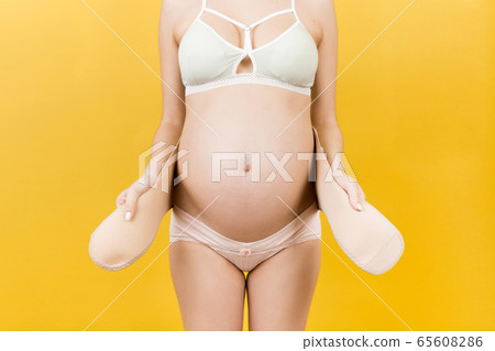 Close up of pregnant woman in colorful underwear Close up of pregnant woman in colorful underwear 65608286