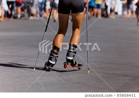 back girl skier roller skiing race 65608431