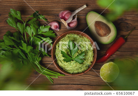 guacamole in a wooden bowl guacamole in a wooden bowl 65610067