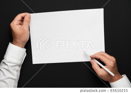a blank sheet of paper and a businessman's hands a blank sheet of paper and a businessman's hands 65610255