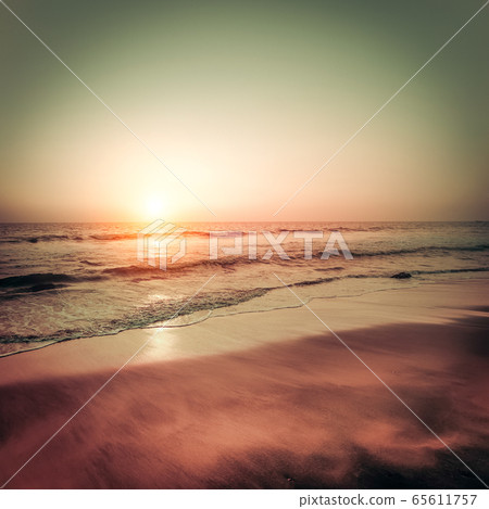 Beautiful sunset at tropical beach. Ocean sandy 65611757