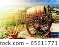 Wooden barrel with vine on cart 65611771