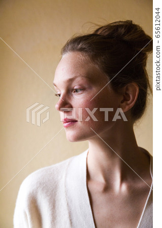 Studio shot of young cute woman isolated on beige Studio shot of young cute woman isolated on beige 65612044