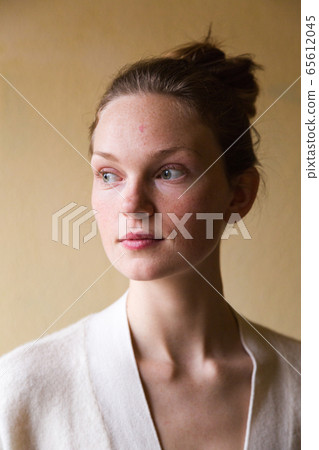 Studio shot of young cute woman isolated on beige Studio shot of young cute woman isolated on beige 65612045