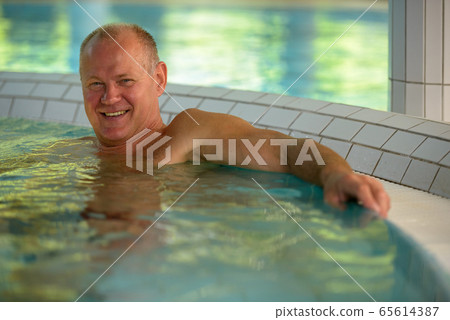 Face of happy senior tourist man relaxing at the spa Face of happy senior tourist man relaxing at the spa 65614387