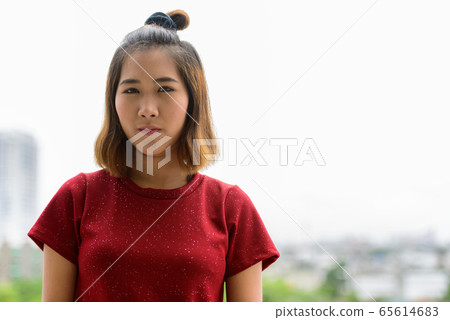 Portrait of young Asian woman with short hair outdoors 65614683