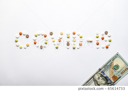 covid-19 inscription with pills and capsules and 100 dollar bill in layout on a white background copy space. Coronavirus, medicine and health, safety concept. covid-19 inscription with pills and capsules and 100 dollar bill in layout on a white background copy space. Coronavirus, medicine and health, safety concept. 65614733