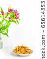 Trendy pancake cereal meal and flowers on background. Tiny baked pancakes. Breakfast food. 65614853