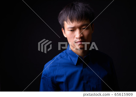 Portrait of young Asian businessman thinking and looking away Portrait of young Asian businessman thinking and looking away 65615909