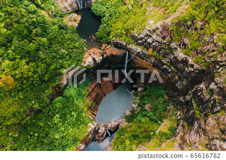 Aerial view from above of the Tamarin waterfall seven cascades in the tropical jungles of the island of Mauritius 65616782