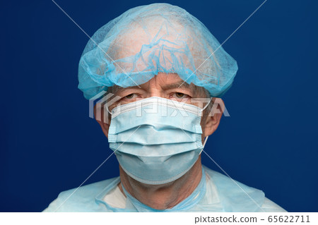 Portrait of senior adult dressed in surgical face mask, covering nose and mouth from SARS, virulently infectious disease corona virus 65622711