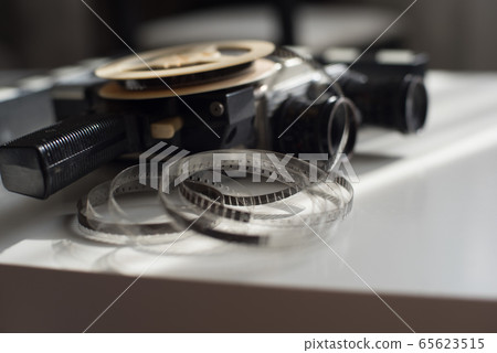 Film reel roll with movie camera and movie clapper 65623515