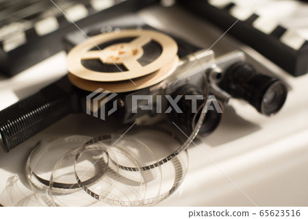 Film roll with movie camera and movie clapper 65623516