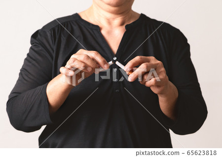 Quit smoking, no tobacco day, mother hands breaking the cigarette Quit smoking, no tobacco day, mother hands breaking the cigarette 65623818
