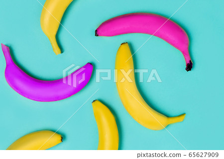 Close up of yellow, pink and purple bananas on a Close up of yellow, pink and purple bananas on a 65627909