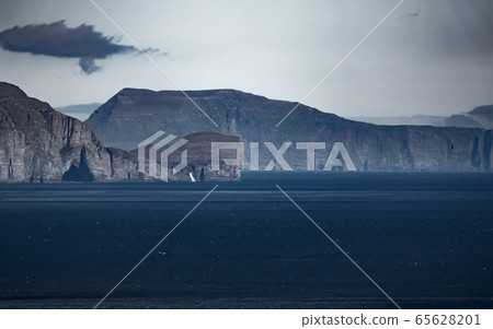 Steep coastline of Faroe Islands with waterfall Steep coastline of Faroe Islands with waterfall 65628201