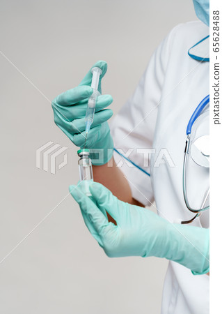 health medical worker woman holding vaccine and syringe 65628488