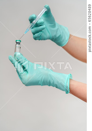health medical worker woman holding vaccine and syringe 65628489