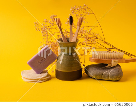 Zero waste beauty routine products on yellow 65630006