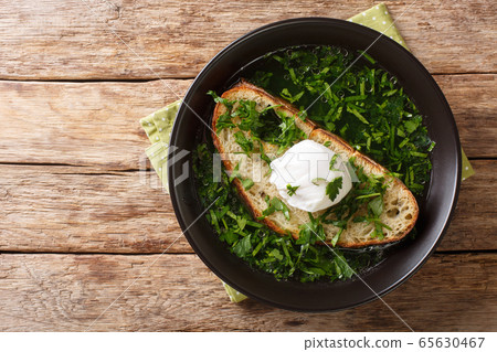 Tasty Portuguese Acorda soup with greens, garlic, 65630467