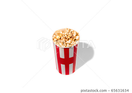 Striped white red bucket full of popcorn isolated on white studio background with copyspace Striped white red bucket full of popcorn isolated on white studio background with copyspace 65631634