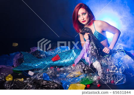 Fantasy mermaid in deep ocean shocked because water pollution. Plastic water bottles and bags pollution on sea floor. Environmental problem. Fantasy mermaid in deep ocean shocked because water pollution. Plastic water bottles and bags pollution on sea floor. Environmental problem. 65631844