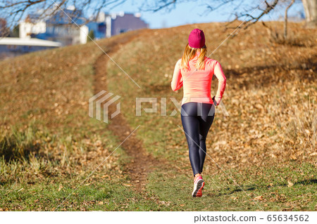 Young slim woman running in park in the morning Young slim woman running in park in the morning 65634562