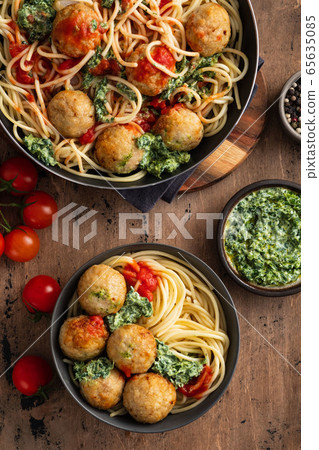 Pasta with meatballs and spinach with tomato sauce. 65635085