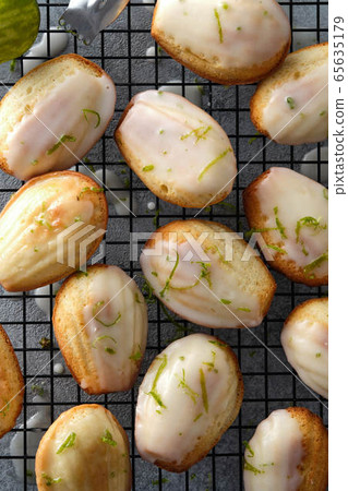 Handmade madeleine on cooling rack, traditional french small cake cookie on gray table Handmade madeleine on cooling rack, traditional french small cake cookie on gray table 65635179