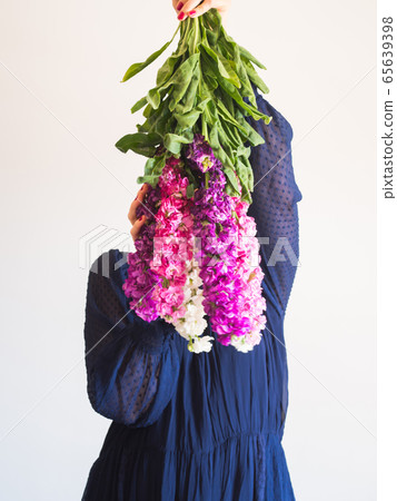 Creative female faceless portrait with bunch of flowers 65639398