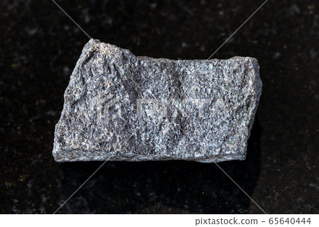 unpolished Chromite rock on black 65640444