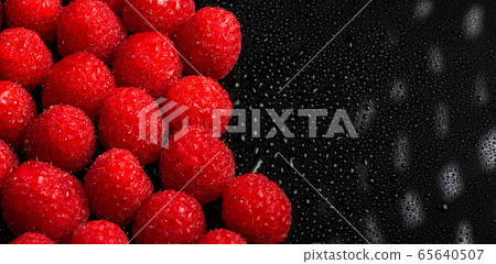 Fresh sweet raspberries close up on black 65640507