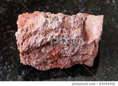 rough Bauxite rock on black 65640560