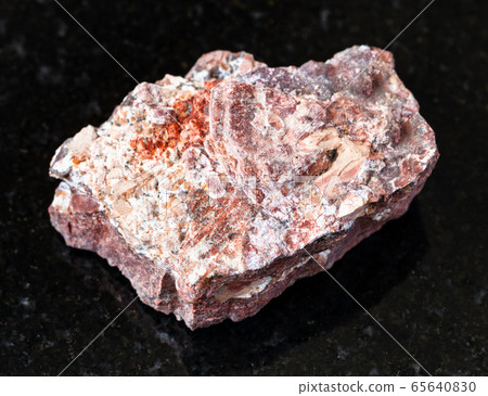 unpolished Rhyolite rock on black 65640830