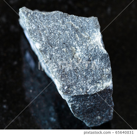 unpolished Andesite rock on black 65640831