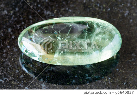 tumbled Prasiolite (green quartz) rock on black 65640837