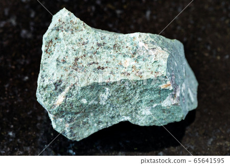 unpolished Tinguaite rock on black 65641595