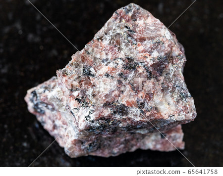 unpolished pink Granite rock on black unpolished pink Granite rock on black 65641758