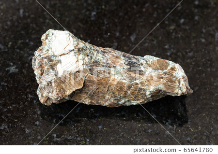 unpolished Bronzite (Enstatite) rock on black 65641780