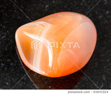 rolled Carnelian (Cornelian) rock on black rolled Carnelian (Cornelian) rock on black 65641924