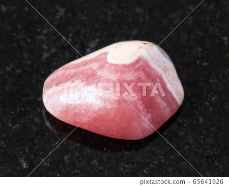 polished Rhodochrosite rock on black 65641926