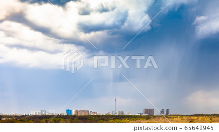 rain and rainy clouds over city and park in spring 65641945