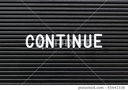 Black felt board with white alphabet in word continue background Black felt board with white alphabet in word continue background 65642336