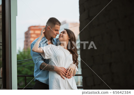 Quarantine lockdown, stay home concept - young beautiful caucasian couple enjoying new lifestyle during coronavirus worldwide health emergency 65642384