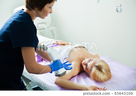 Skin care. Woman is in the process at the clinic lipomassage. 65643109