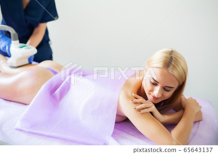 Skin care. Woman is in the process at the clinic lipomassage. Skin care. Woman is in the process at the clinic lipomassage. 65643137