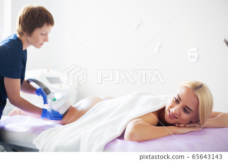 Skin care. Woman is in the process at the clinic lipomassage. Skin care. Woman is in the process at the clinic lipomassage. 65643143
