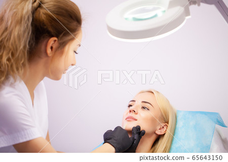 Lip Augmentation In Cosmetology Clinic. Beautiful Woman Getting Beauty Injection For Lips 65643150