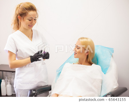 Lip Augmentation In Cosmetology Clinic. Beautiful Woman Getting Beauty Injection For Lips 65643155