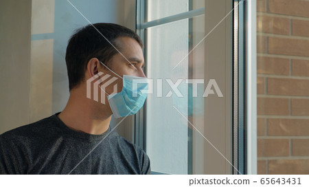 Sick man in medical mask is on self-isolation 65643431